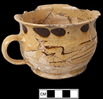 North Midlands slip decorated handled drinking pot/cup decorated with dotted, trailed and combed decoration. Rim diameter: 4.75”; Vessel Height: 3.25”; Object  ID:  2648. Learn more about this object at: http://mountvernonmidden.org/default.html